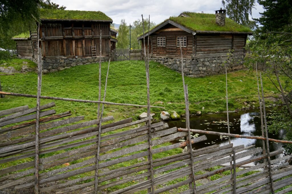 A fenced in area with two wooden buildings